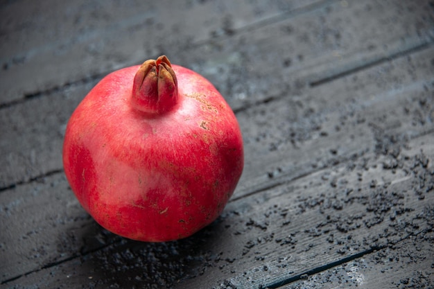 Free photo top side view ripe pomegranate ripe pomegranate on wooden table