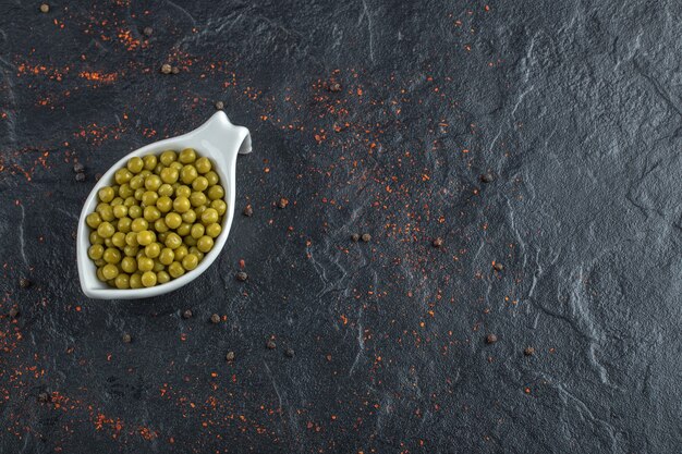 Top up view of green peas in bowl  .