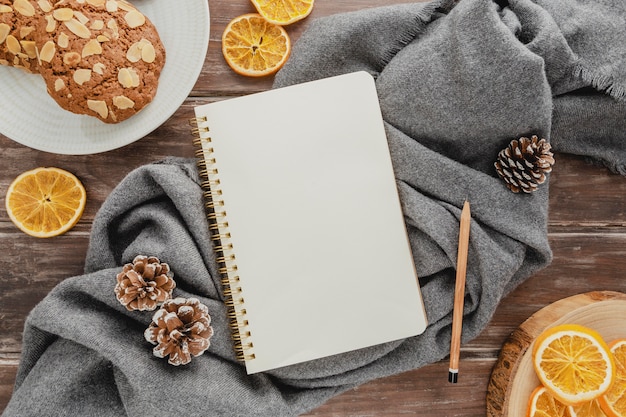 Top view agenda with cookies and pine cones