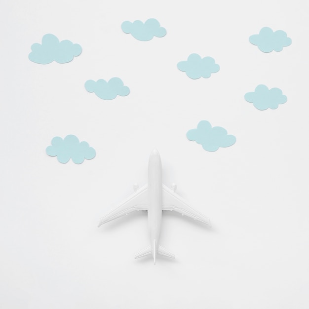 Free Photo top view airplane toy with clouds