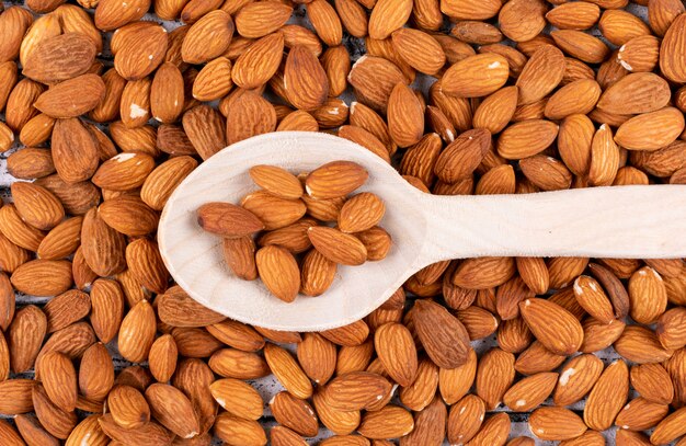 Top view almond in wooden spoon