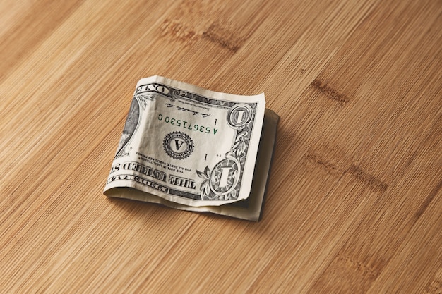 Free photo top view of an american dollar bill on a wooden surface