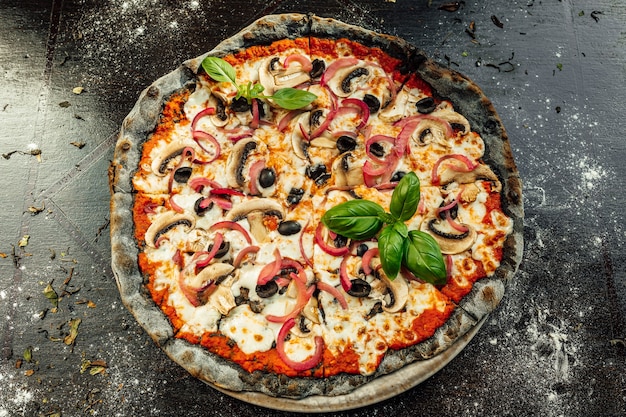 Free photo top view of appetizing pizza with black dough and various vegetables