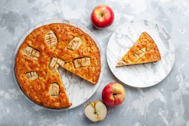 Top view apple pie inside plate with apples on the light background sugar cake biscuit pie sweet bake