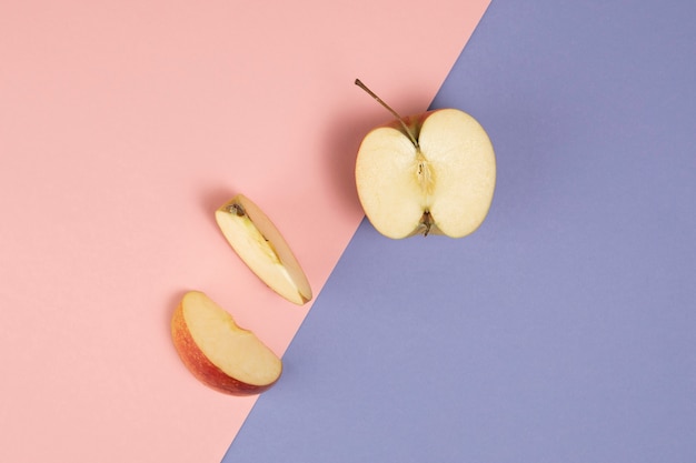 Free photo top view of apple on pink and purple background