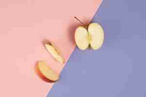 Free photo top view of apple on pink and purple background