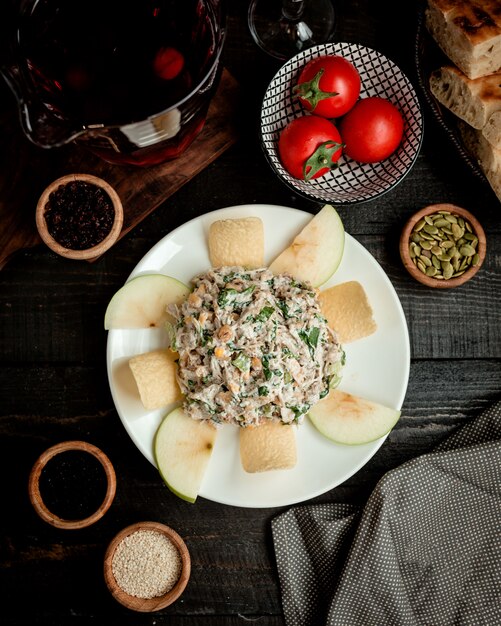 Top view of apple salad plate with corn lettuce, chicken, mayonnaise and raisins