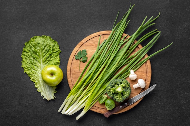 Top view of apple with chives and broccoli