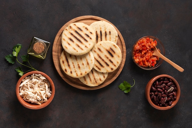 Top view arepas on wooden board