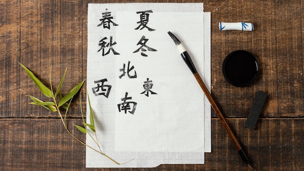 Free Photo top view arrangement of chinese symbols written with ink