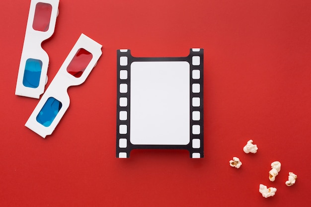 Free photo top view arrangement of movie elements on red background