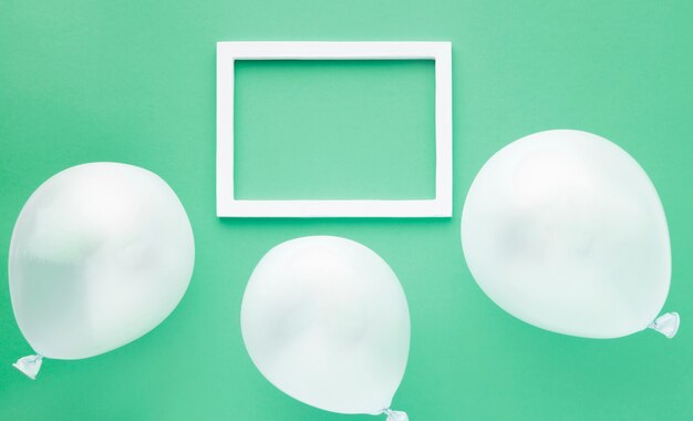 Top view arrangement with balloons on green background