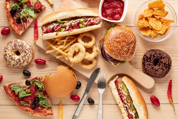 Top view arrangement with food on wooden background