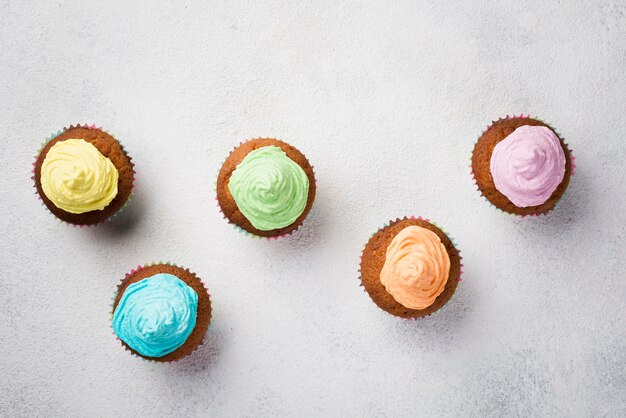 Top view arrangement with glazed muffins and white background