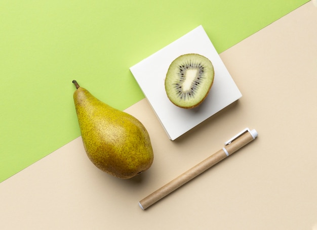 Top view arrangement with stationery elements and fruits