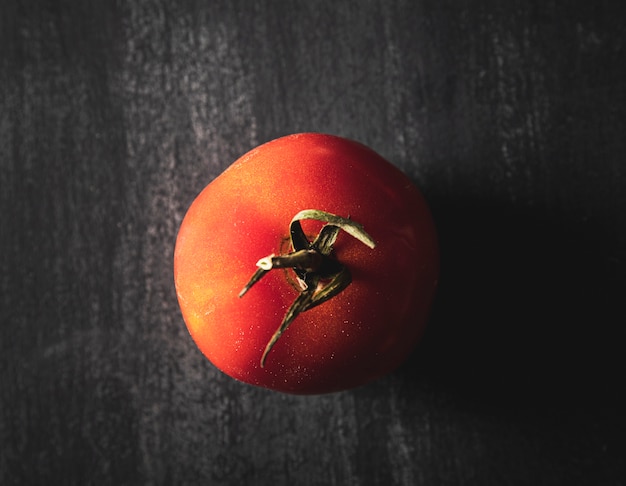 Top view arrangement with tomato on black background