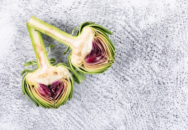 Top view artichokes slices on light gray background. horizontal space for text