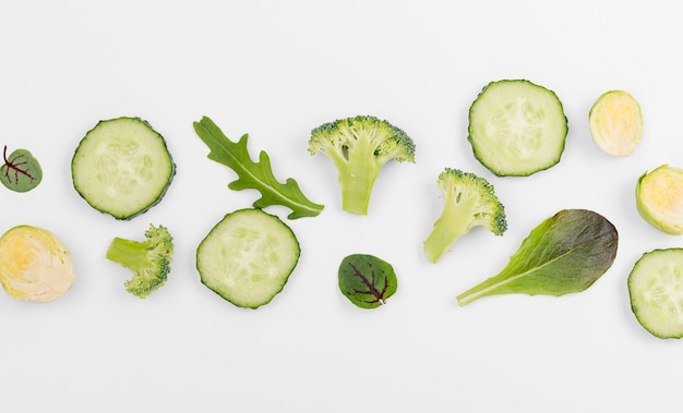 Top view assortment of broccoli and cucumber slices