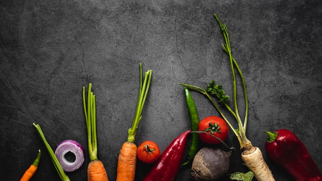 Free photo top view assortment of carrots and other veggies