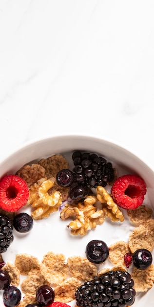 Top view assortment of healthy bowl cereals with berries with copy space