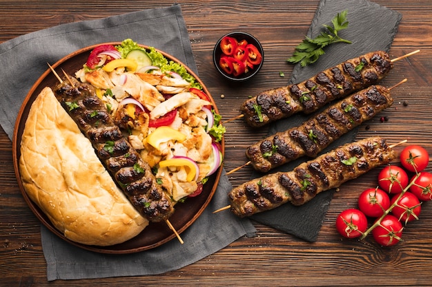 Free Photo top view of assortment of tasty kebabs with tomatoes and vegetables