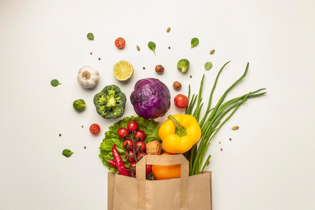 Free photo top view of assortment of vegetables in paper bag