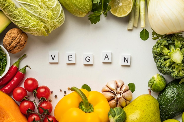 Top view of assortment of vegetables with the word vegan