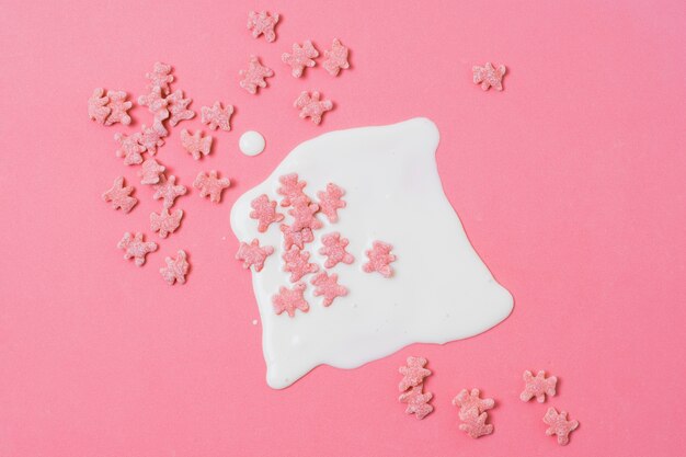 Top view assortment with pink cereals on pink background