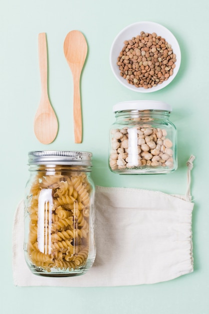 Top view assortment of zero waste products on green background