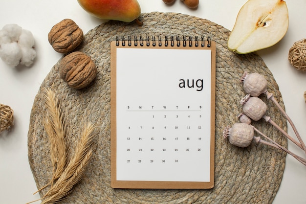 Free photo top view august calendar and nuts