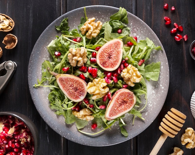 Top view of autumn fig salad on plate with walnuts