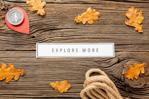 Free photo top view autumn leaves and a compass