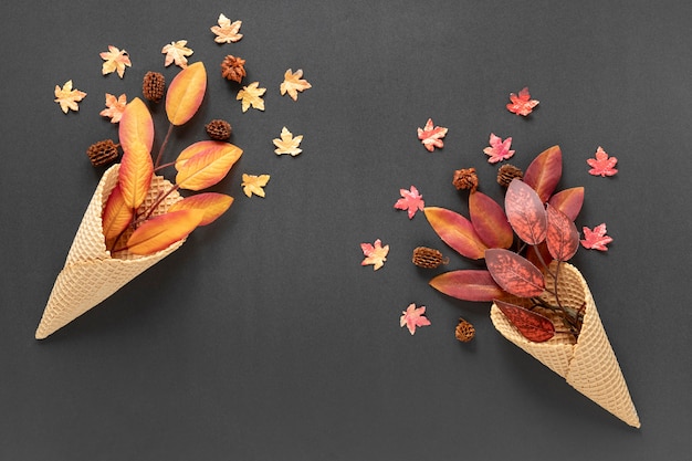 Free Photo top view autumn leaves in ice cream cones