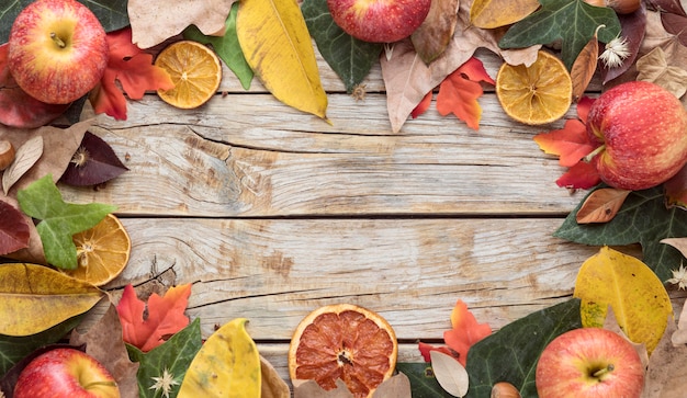 Free photo top view of autumn leaves with copy space and dried citrus