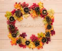 Free photo top view autumn leaves on wooden table