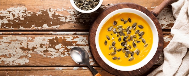 Top view of autumn squash soup with seeds and copy space