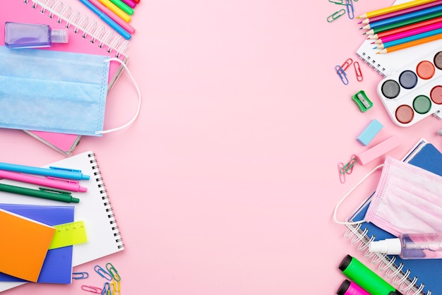 Top view of back to school essentials with medical mask and pencils