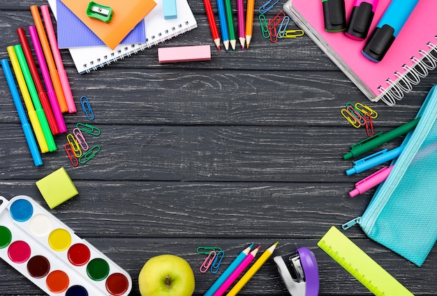 Free photo top view of back to school stationery with apple and copy space