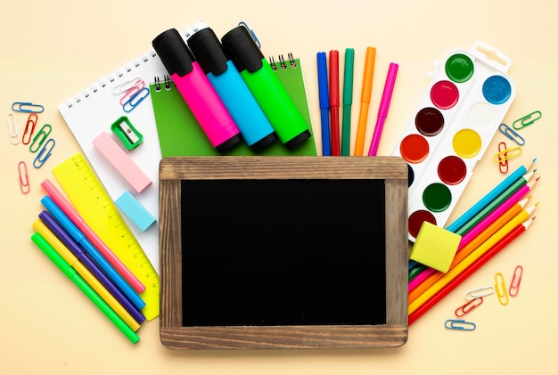 Top view of back to school stationery with colored pencils and watercolor