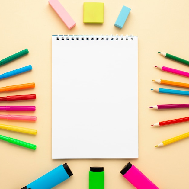 Top view of back to school stationery with notebook and pencils