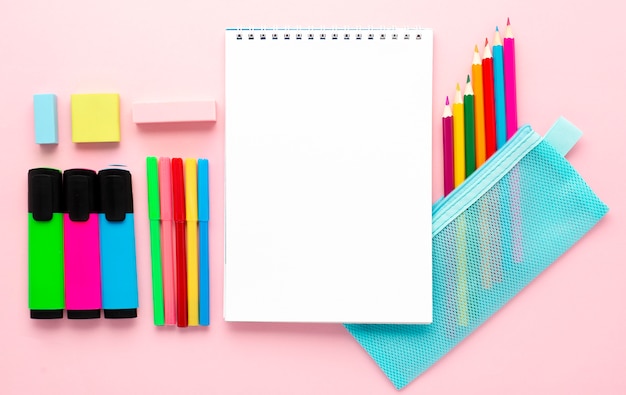 Top view of back to school stationery with notebook and pencils