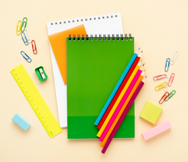 Free Photo top view of back to school stationery with notebooks and colored pencils