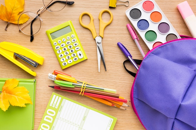 Top view of back to school supplies with pencils and backpack