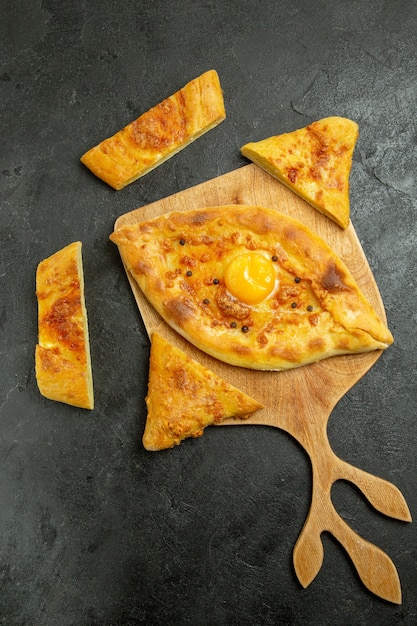 Top view baked egg bread delicious dough bun on a dark space