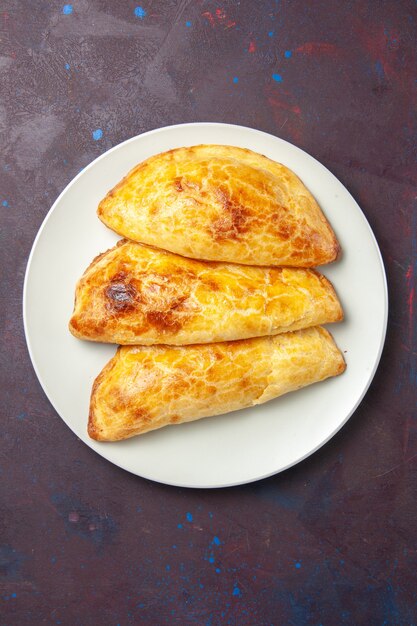 Top view baked pastries bread like inside plate on dark space