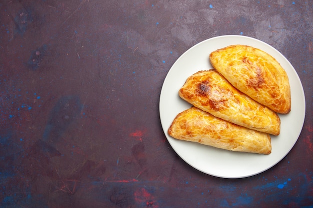 Free photo top view baked pastries bread like inside plate on the dark space