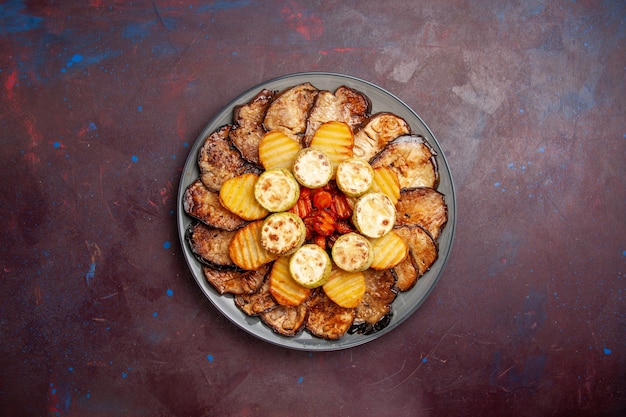 Free Photo top view baked vegetables potatoes and eggplants inside plate on a dark space