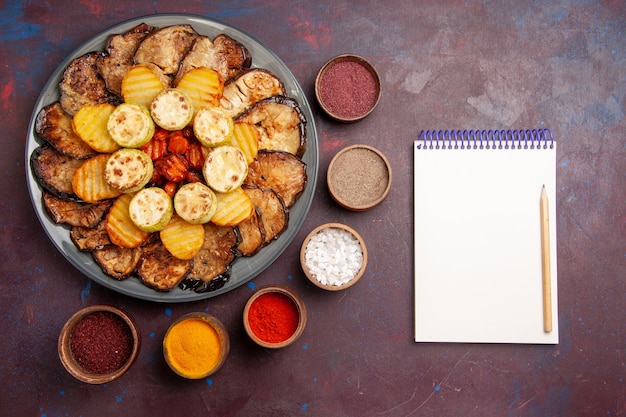 Free Photo top view baked vegetables potatoes and eggplants with seasonings on dark space