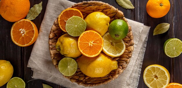 Top view of basket of oranges and limes