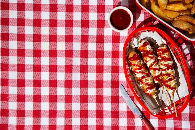 Top view basket with corn dogs and copy space